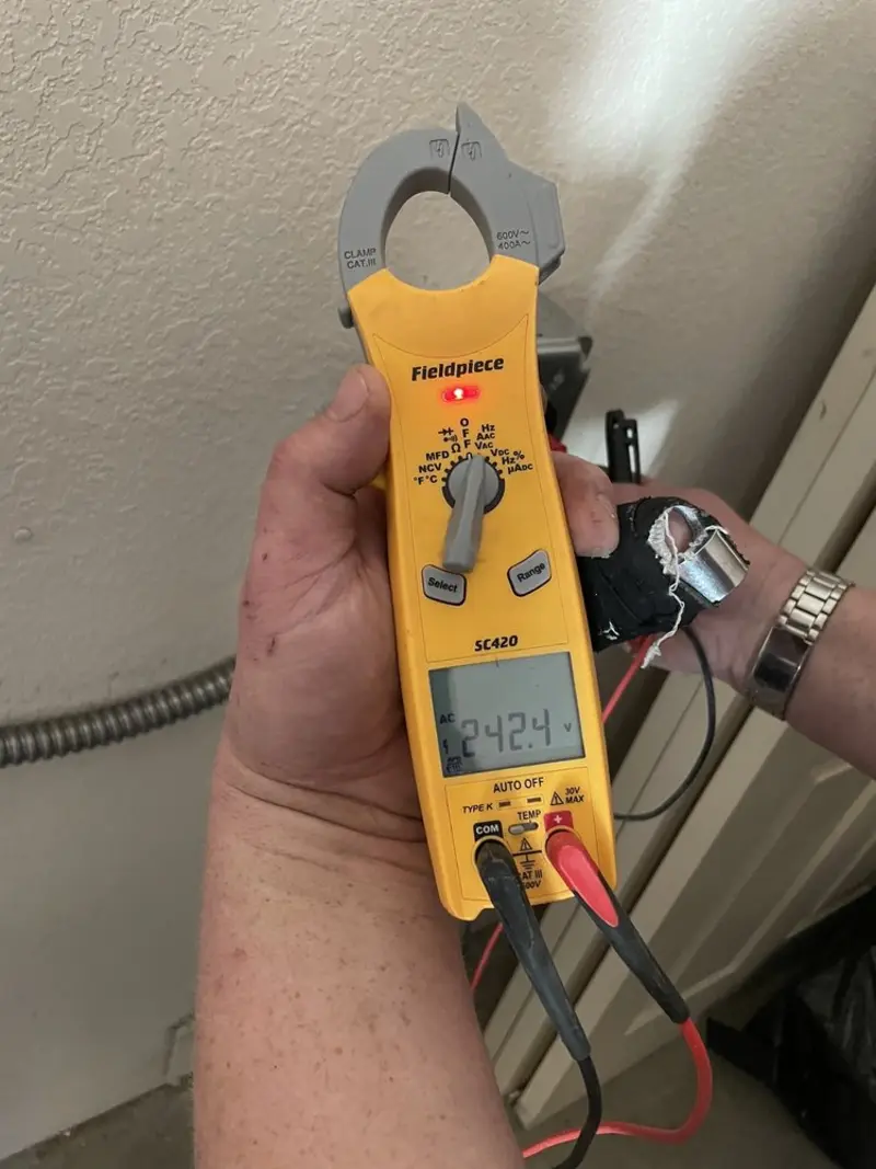 Voltage testing with clamp meter during Outlet Installation in Fargo